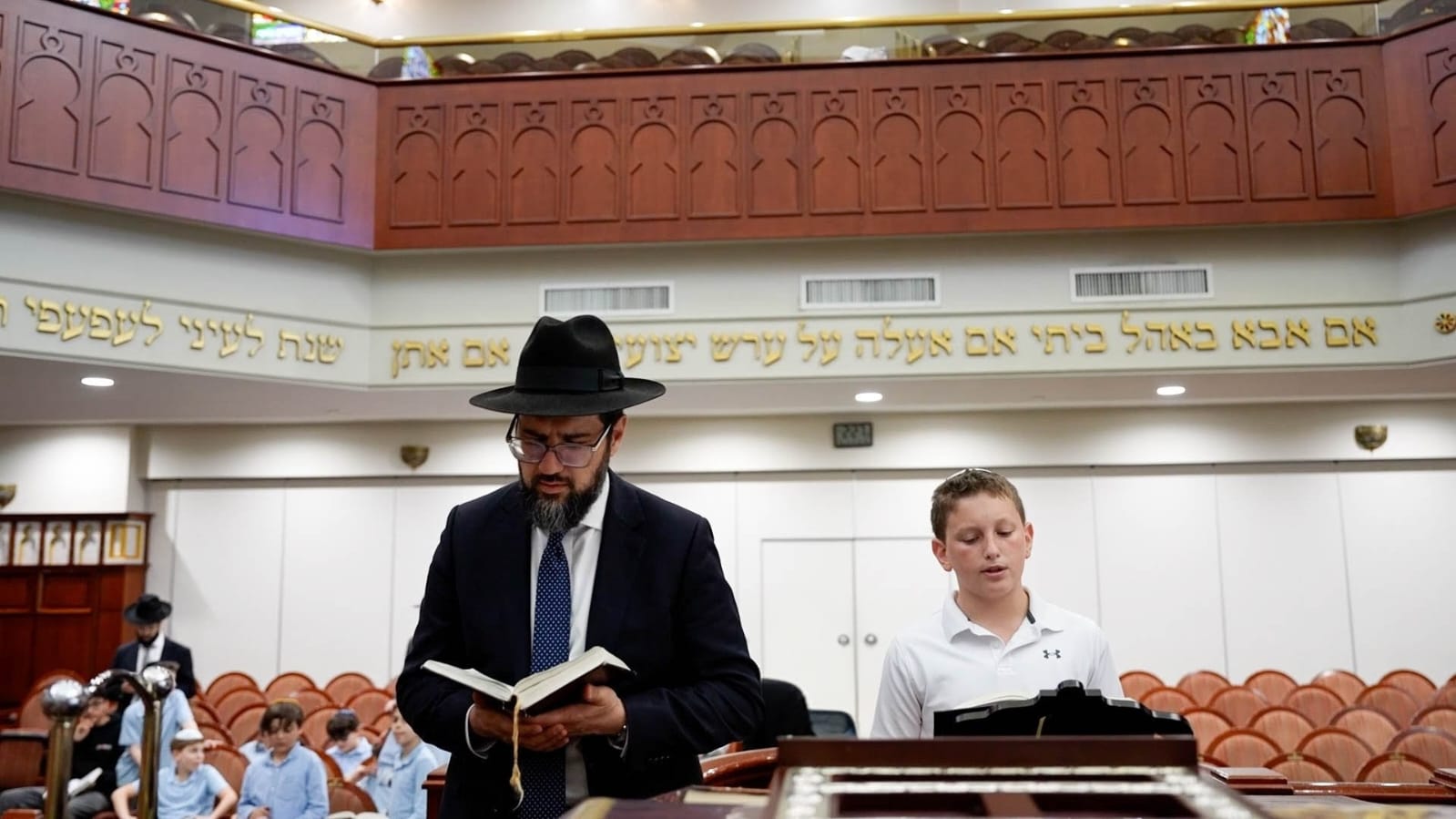 Rabbi Azoulay praying with a student
